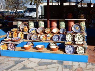 a flea market stall of colourfully painted ceramic bowls.